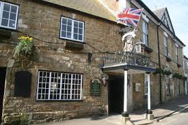 The Ilchester Arms Hotel on Market Street, Abbotsbury, with its balcony and hanging lantern